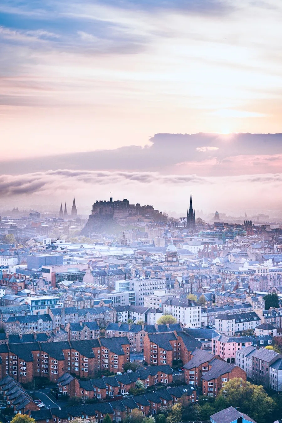 Edinburgh Castle at sunrise above the tenement rooftops of south Edinburgh
